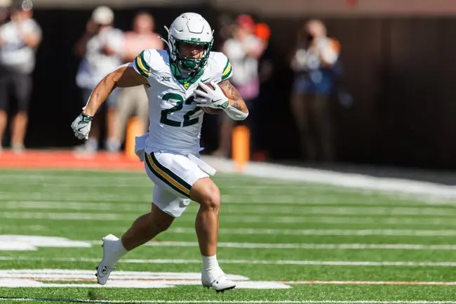 Sep 27, 2025; Stillwater, Oklahoma, USA; Baylor Bears running back Caden Knighten (22) runs the ball during the first half against the Oklahoma State Cowboys at Boone Pickens Stadium. Mandatory Credit: William Purnell-Imagn Images