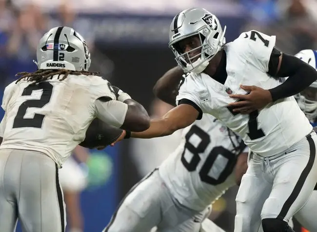 Las Vegas Raiders quarterback Geno Smith (7) hands off the ball to running back Ashton Jeanty (2) Sunday, Oct. 5, 2025, during a game against the Indianapolis Colts at Lucas Oil Stadium in Indianapolis. The Colts defeated the Raiders 40-6.