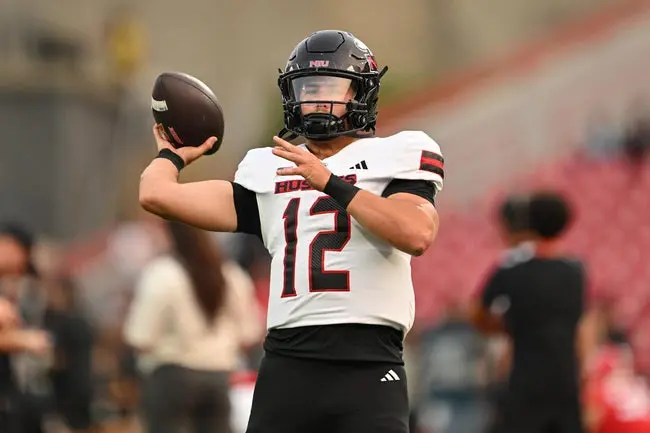 Sep 5, 2025; College Park, Maryland, USA; Northern Illinois Huskies quarterback Jackson Proctor (12) warms up before a game against the Maryland Terrapins at SECU Stadium. Mandatory Credit: Jamie Sabau-Imagn Images