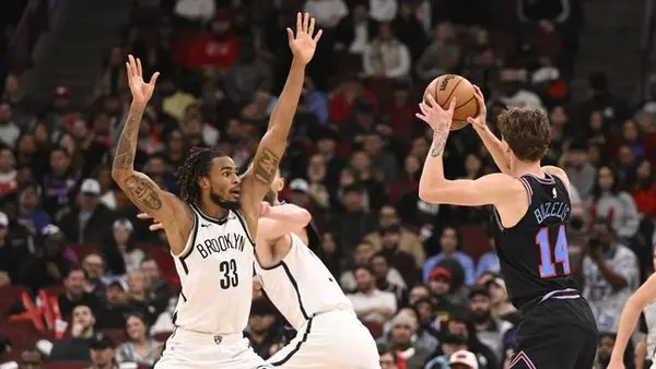 Dec 3, 2025; Chicago, Illinois, USA; Brooklyn Nets center Nic Claxton (33) defends Chicago Bulls forward Matas Buzelis (14) during the second half at the United Center. Mandatory Credit: Matt Marton-Imagn Images