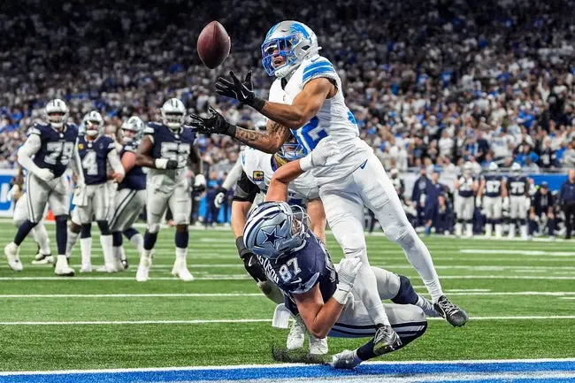 featured-image-1765415164774 Detroit Lions safety Brian Branch (32) tries to intercept a pass intended for Dallas Cowboys tight end Jake Ferguson (87) during the second half at Ford Field in Detroit on Thursday, Dec. 4, 2025.