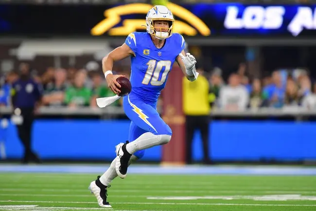 Dec 8, 2025; Inglewood, California, USA; Los Angeles Chargers quarterback Justin Herbert (10) runs against the Philadelphia Eagles in the second half at SoFi Stadium. Mandatory Credit: Gary A. Vasquez-Imagn Images