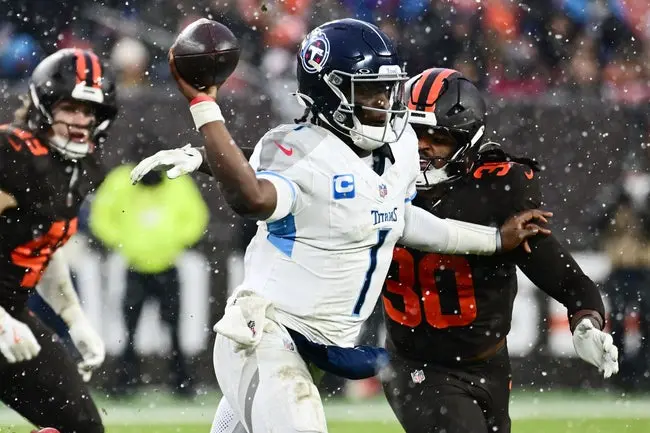 featured-image-1765416952246 Dec 7, 2025; Cleveland, Ohio, USA; Tennessee Titans quarterback Cam Ward (1) throws a pass as Cleveland Browns linebacker Devin Bush (30) rushes during the fourth quarter at Huntington Bank Field. Mandatory Credit: Ken Blaze-Imagn Images