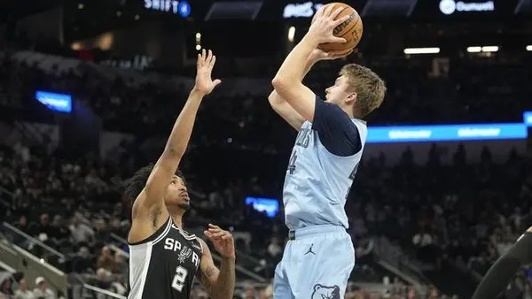 Dec 2, 2025; San Antonio, Texas, USA; Memphis Grizzlies guard Cam Spencer (24) shoots over San Antonio Spurs guard Dylan Harper (2) during the second half at Frost Bank Center. Mandatory Credit: Scott Wachter-Imagn Images