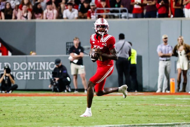 Aug 28, 2025; Raleigh, North Carolina, USA; North Carolina State Wolfpack quarterback CJ Bailey (11) runs with the ball during the second half of the game against East Carolina Pirates at Carter-Finley Stadium. Mandatory Credit: Jaylynn Nash-Imagn Images
