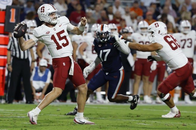 Sep 20, 2025; Charlottesville, Virginia, USA; Stanford Cardinal quarterback Ben Gulbranson (15) throws a sixty yard pass to Cardinal wide receiver Bryce Farrell (not pictured) as Virginia Cavaliers defensive end Mitchell Melton (17) defends during the first quarter at Scott Stadium. Mandatory Credit: Geoff Burke-Imagn Images