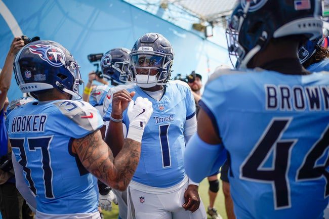 Tennessee Titans quarterback Cam Ward (1), safety Amani Hooker (37) and safety Mike Brown (44) talk before the game against the Indianapolis Colts at Nissan Stadium in Nashville, Tenn., Sunday, Sept. 21, 2025.