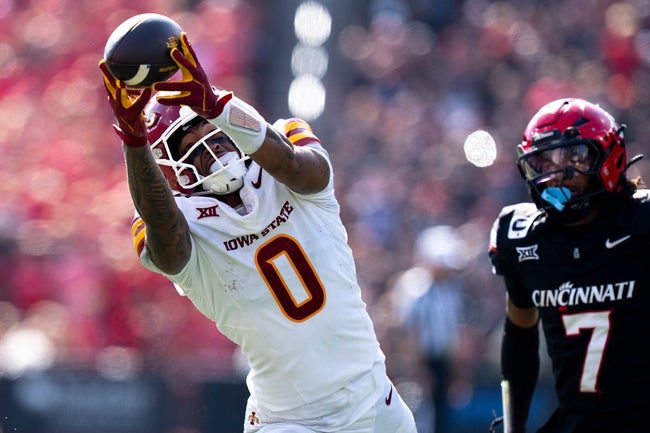Iowa State Cyclones wide receiver Chase Sowell (0) catches a pass for a first down on fourth down was Cincinnati Bearcats cornerback Logan Wilson (7) defends in the fourth quarter of the NCAA football game between the Cincinnati Bearcats and Iowa State Cyclones at Nippert Stadium in Cincinnati on Oct. 4, 2025.
