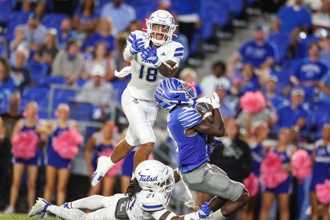 Oct 4, 2025; Memphis, Tennessee, USA; Memphis Tigers wide receiver Jamari Hawkins (9) catches the ball between Tulsa Golden Hurricane defensive back Zach Williams (18) and defensive back Lento Smith Jr. (21) during the first half at Simmons Bank Liberty Stadium. Mandatory Credit: Wesley Hale-Imagn Images