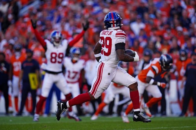 Oct 19, 2025; Denver, Colorado, USA; New York Giants running back Tyrone Tracy Jr. (29) runs the ball during the second half against the Denver Broncos at Empower Field at Mile High. Mandatory Credit: Ron Chenoy-Imagn Images