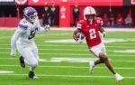 Oct 25, 2025; Lincoln, Nebraska, USA; Nebraska Cornhuskers wide receiver Jacory Barney Jr. (2) runs with the ball against Northwestern Wildcats defensive lineman Richie Hagarty (52) during the second quarter at Memorial Stadium. Mandatory Credit: Dylan Widger-Imagn Images