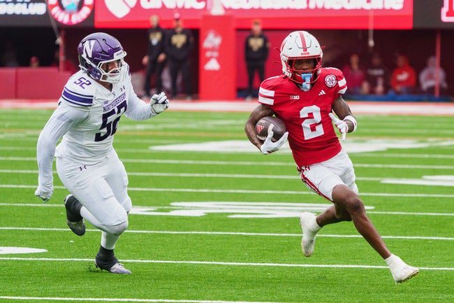 Oct 25, 2025; Lincoln, Nebraska, USA; Nebraska Cornhuskers wide receiver Jacory Barney Jr. (2) runs with the ball against Northwestern Wildcats defensive lineman Richie Hagarty (52) during the second quarter at Memorial Stadium. Mandatory Credit: Dylan Widger-Imagn Images