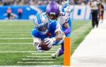 Detroit Lions wide receiver Jameson Williams (1) dives for a touchdown against Minnesota Vikings cornerback Isaiah Rodgers (2) during the second half at Ford Field in Detroit on Sunday, November 2, 2025.