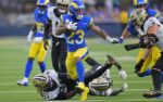 Nov 2, 2025; Inglewood, California, USA; Los Angeles Rams running back Kyren Williams (23) carries the ball as he runs over. New Orleans Saints safety Justin Reid (21) during the second half at SoFi Stadium. Mandatory Credit: Jayne Kamin-Oncea-Imagn Images