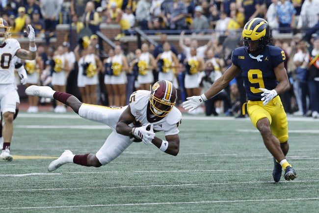 Sep 13, 2025; Ann Arbor, Michigan, USA; Central Michigan Chippewas defensive back Caleb Spann (15) tries to make an interception of a pass attended for Michigan Wolverines wide receiver Channing Goodwin (9) in the first half at Michigan Stadium. Mandatory Credit: Rick Osentoski-Imagn Images