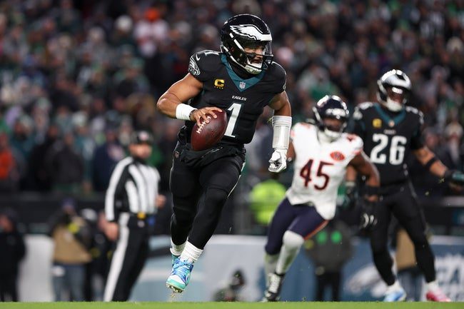 Nov 28, 2025; Philadelphia, Pennsylvania, USA; Philadelphia Eagles quarterback Jalen Hurts (1) scrambles with the ball against the Chicago Bears during the third quarter of the game at Lincoln Financial Field. Mandatory Credit: Bill Streicher-Imagn Images