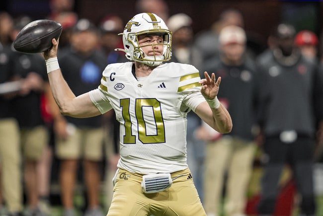 Nov 28, 2025; Atlanta, Georgia, USA; Georgia Tech Yellow Jackets quarterback Haynes King (10) passes the ball against the Georgia Bulldogs during the first half at Mercedes-Benz Stadium. Mandatory Credit: Dale Zanine-Imagn Images