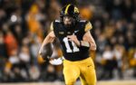 Nov 22, 2025; Iowa City, Iowa, USA; Iowa Hawkeyes quarterback Mark Gronowski (11) scrambles for yards against the Michigan State Spartans during the fourth quarter at Kinnick Stadium. Mandatory Credit: Jeffrey Becker-Imagn Images