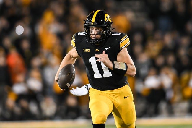Nov 22, 2025; Iowa City, Iowa, USA; Iowa Hawkeyes quarterback Mark Gronowski (11) scrambles for yards against the Michigan State Spartans during the fourth quarter at Kinnick Stadium. Mandatory Credit: Jeffrey Becker-Imagn Images