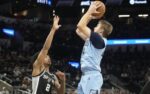 Dec 2, 2025; San Antonio, Texas, USA; Memphis Grizzlies guard Cam Spencer (24) shoots over San Antonio Spurs guard Dylan Harper (2) during the second half at Frost Bank Center. Mandatory Credit: Scott Wachter-Imagn Images