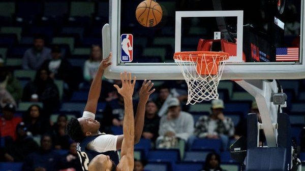 Dec 2, 2025; New Orleans, Louisiana, USA; New Orleans Pelicans center Derik Queen (22) hits the backboard as he makes a shot against Minnesota Timberwolves center Rudy Gobert (27) during overtime at Smoothie King Center. Mandatory Credit: Matthew Hinton-Imagn Images