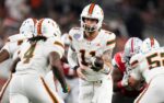 Miami Hurricanes quarterback Carson Beck (11) hands off to running back Mark Fletcher Jr. (4) during the Cotton Bowl at AT&T Stadium in Arlington, Texas for the College Football Playoff quarterfinal game against the Ohio State Buckeyes on Dec. 31, 2025.