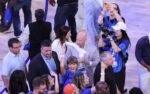 This caption does not contain a basketball player name and team - it's about Taylor Swift cheering at a game. I cannot create the requested alt text format without an actual player and their team from the caption.