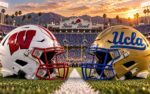 Wisconsin and UCLA helmets set at midfield of the Rose Bowl in Pasadena as the San Gabriel Mountains fade into dusk